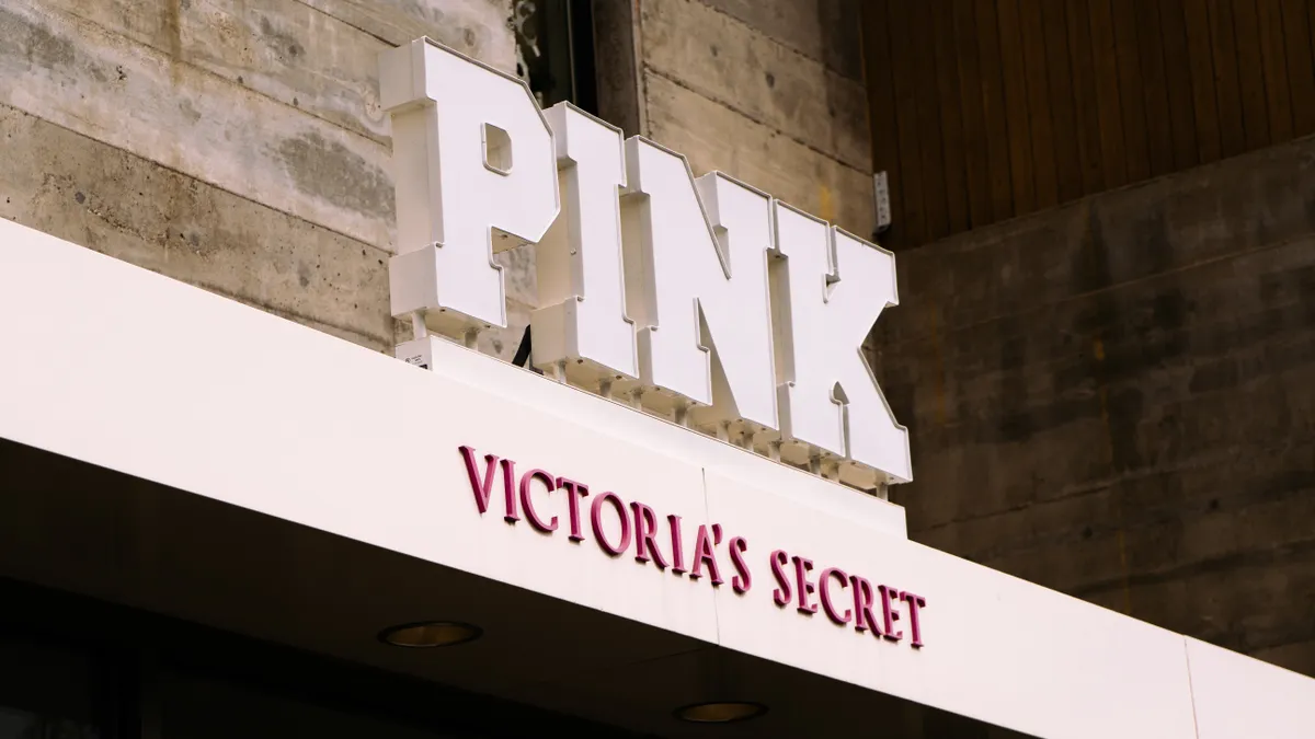 A large sign in light pink block capital letters says "Pink," just above a smaller sign in darker pink that says "Victoria's Secret."