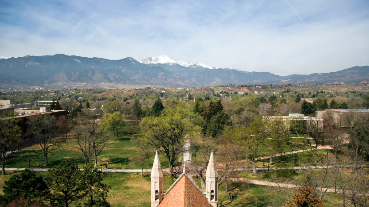 The view of Colorado College's campus from a high angle, looking out to mountains.