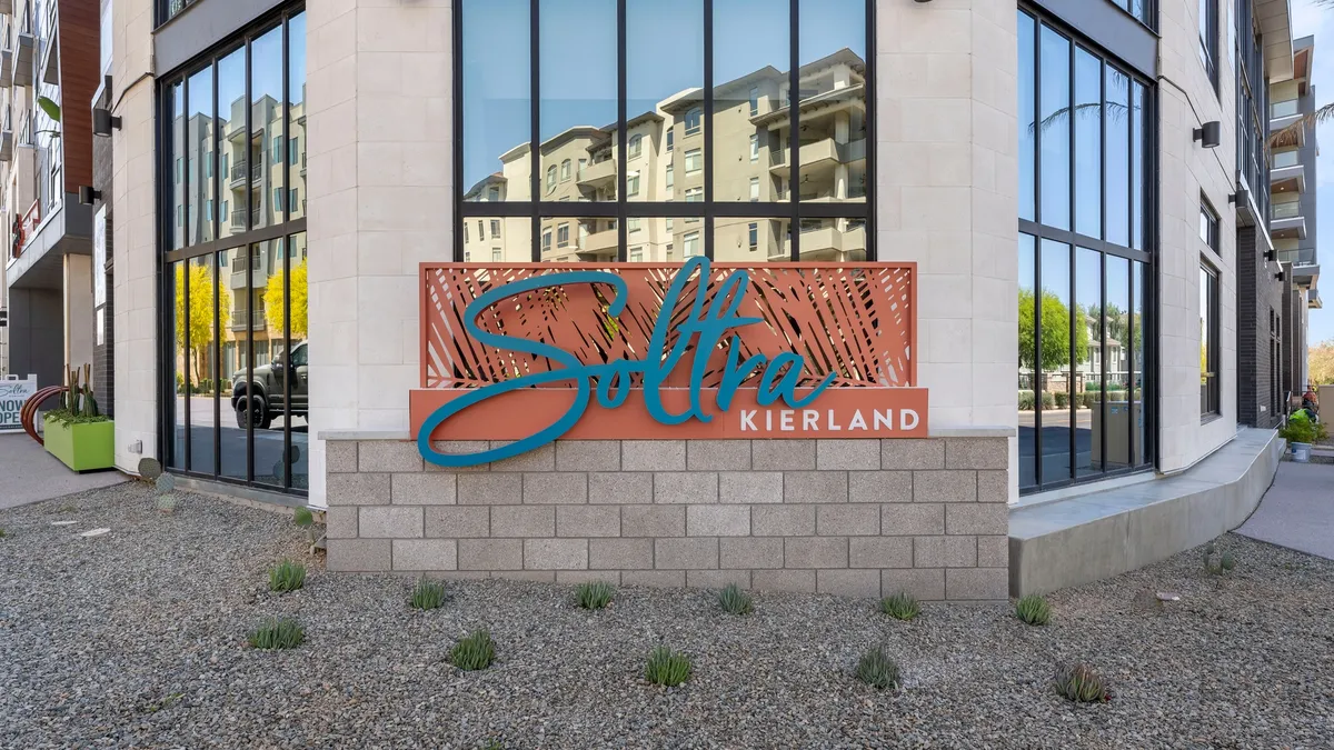 Ground floor of new, white apartment complex with Soltra Kierland sign.