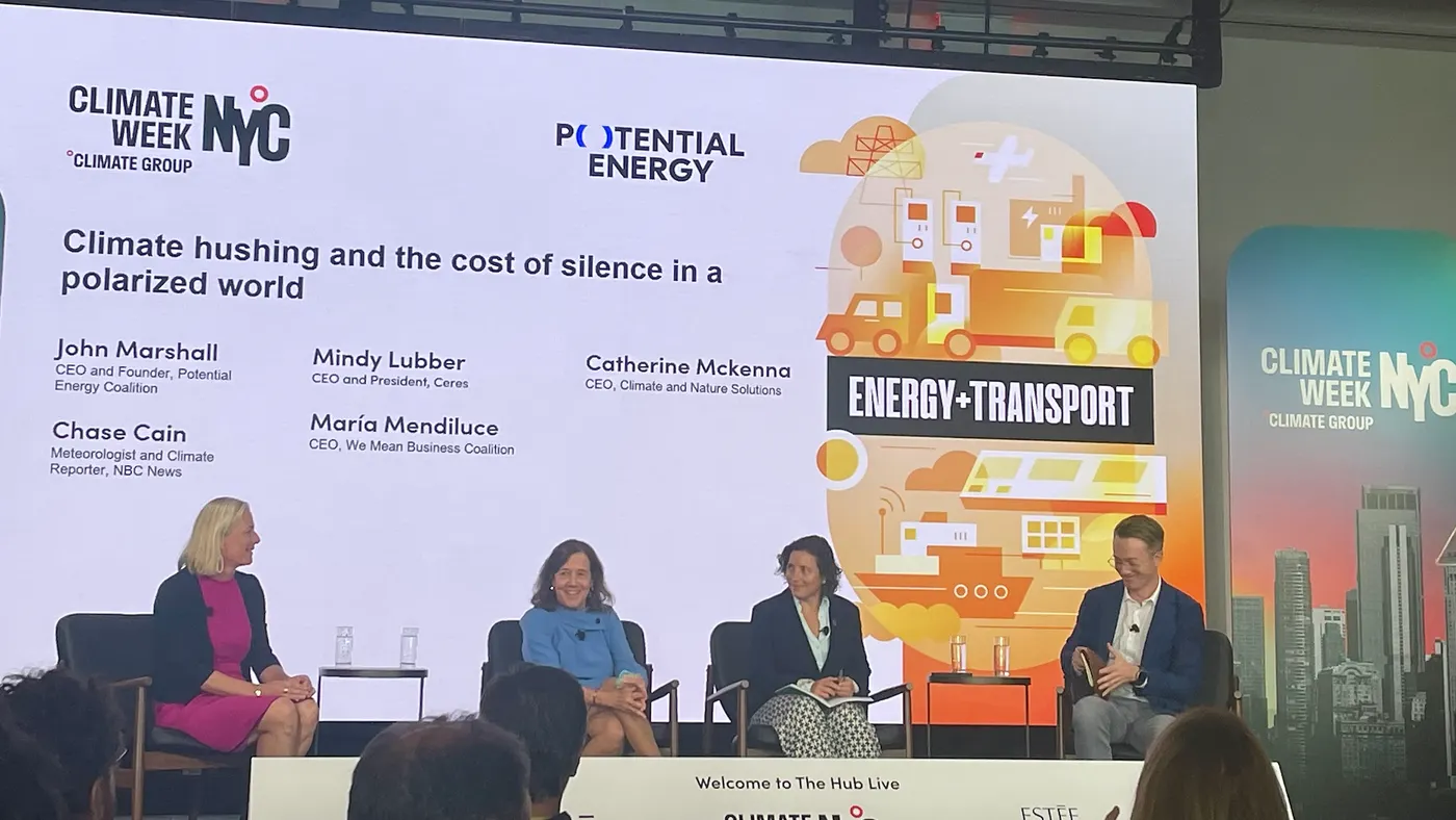 People seen speaking onstage during a panel discussion.