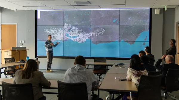 Workshop attendees view a large map of electricity infrastructure.