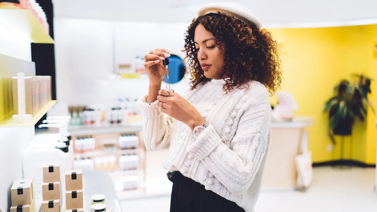 Woman using dropper to test out product