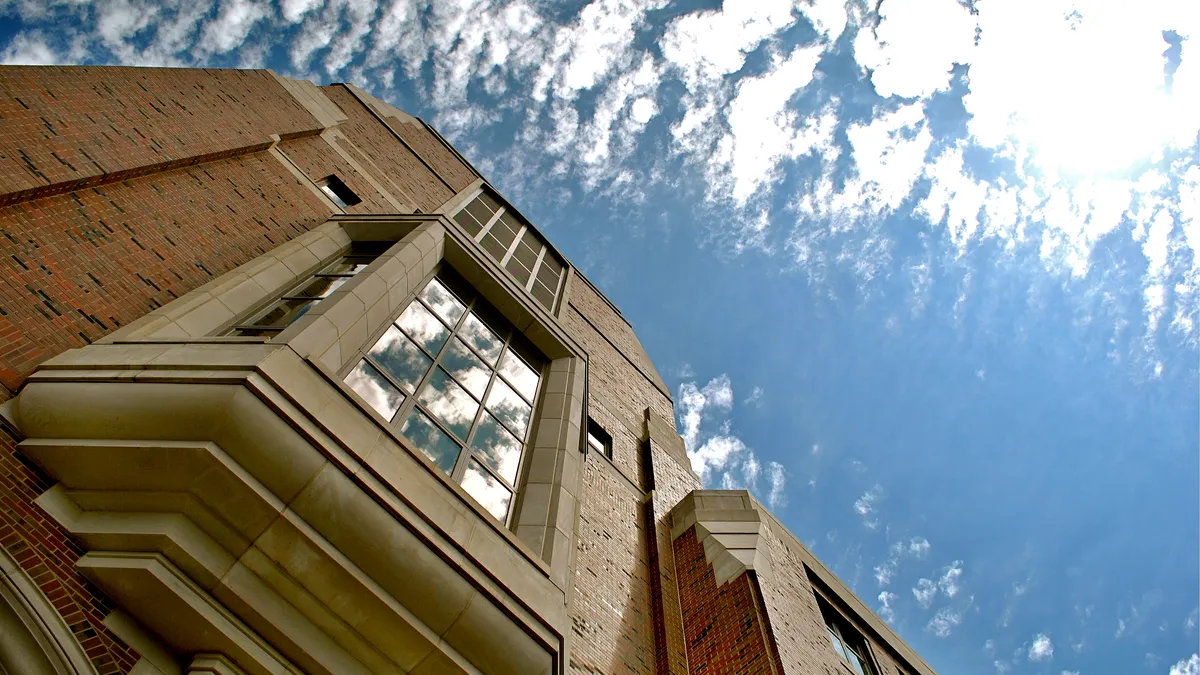 Windows framed in stone jut out from a brick wall at Weill Hall, home of the Gerald R. Ford School of Public Policy at the University of Michigan.