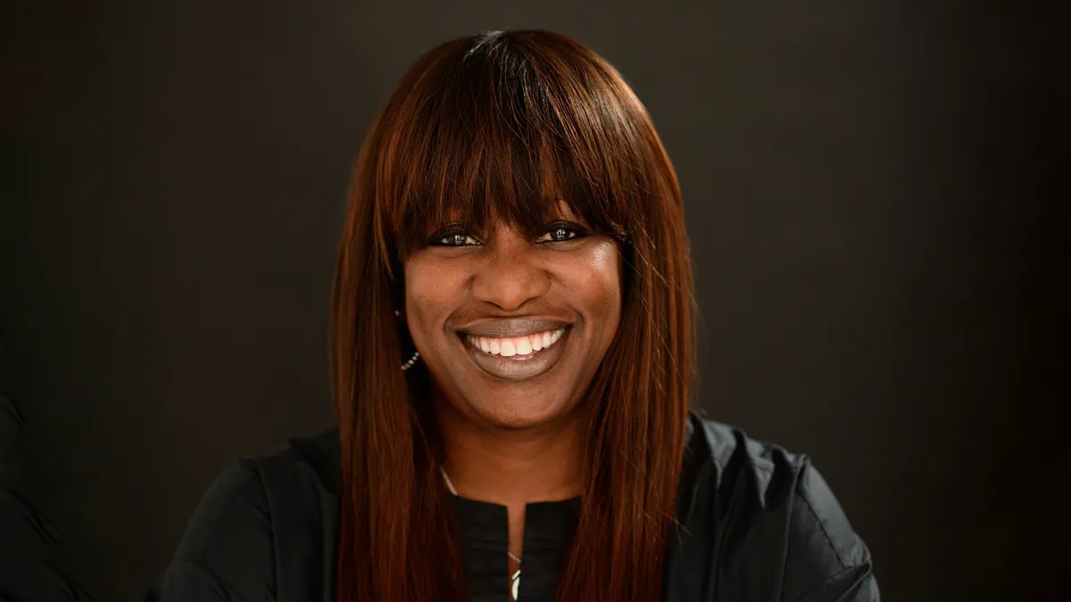 A headshot of Michelle Green against a dark backdrop.