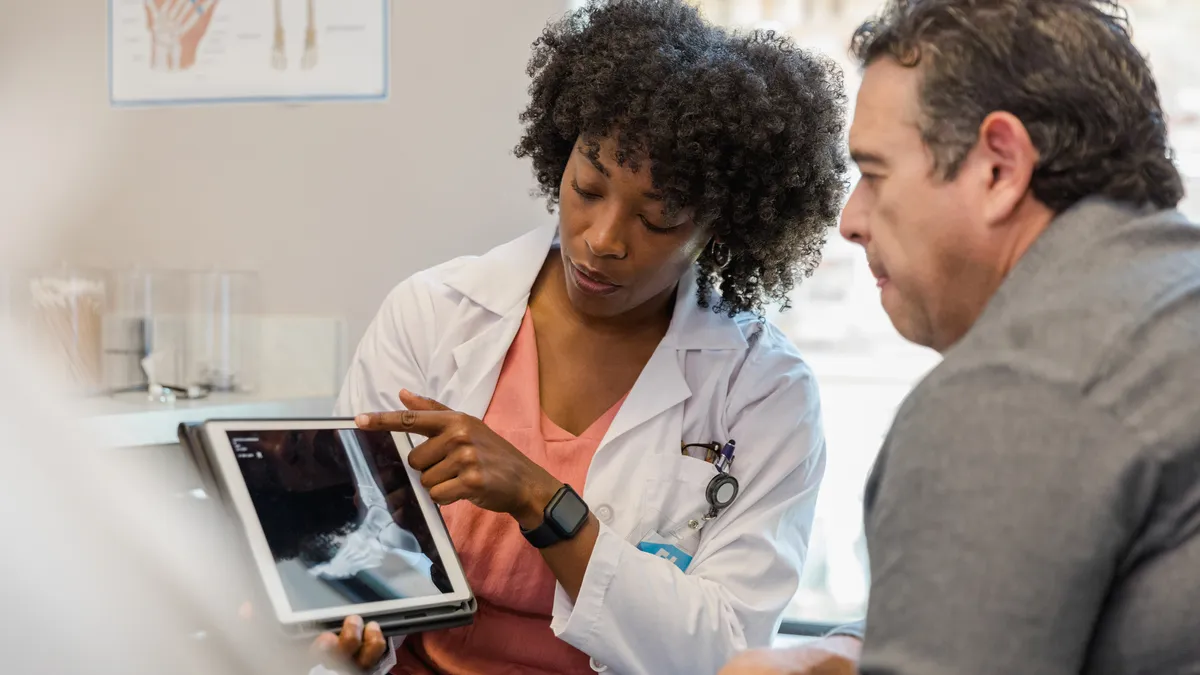 A picture of a doctor consulting about an X-ray with a patient.