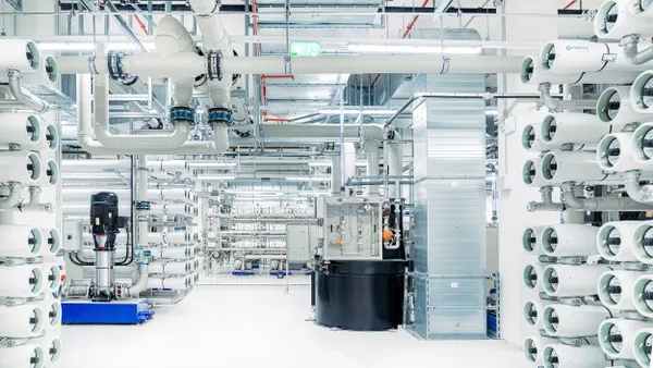 A white room full of pipes and water purification equipment