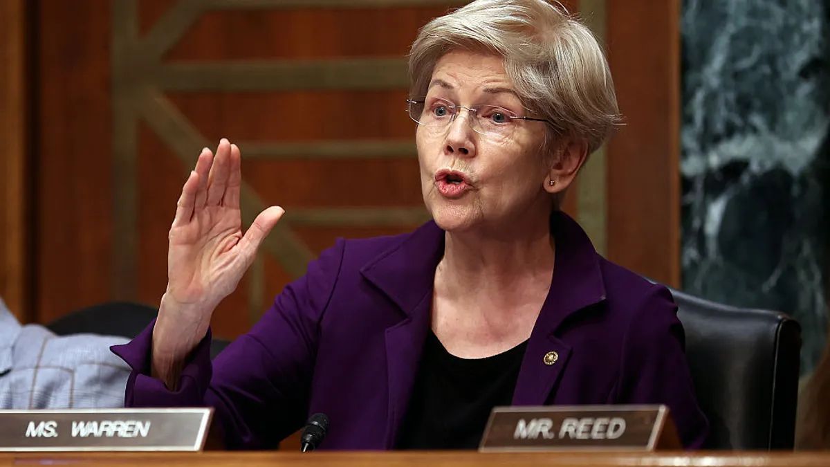 Elizabeth Warren gestures with her right hand while speaking during a hearing.