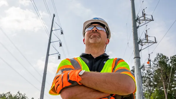 A construction working standing with folding hands