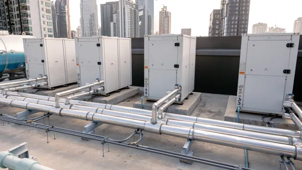 Heat pump compressors installed on the rooftop of a large commercial building