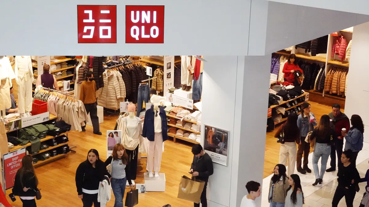 A Uniqlo store is pictured while patrons walk through it.