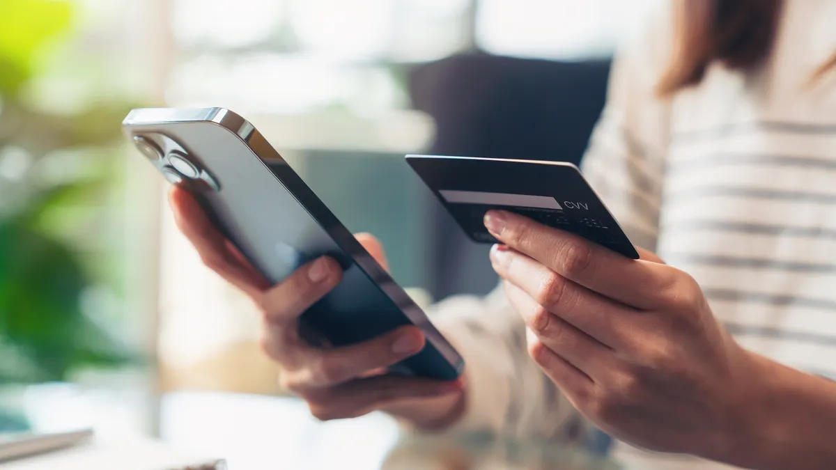 Person uses a phone to pay with credit card