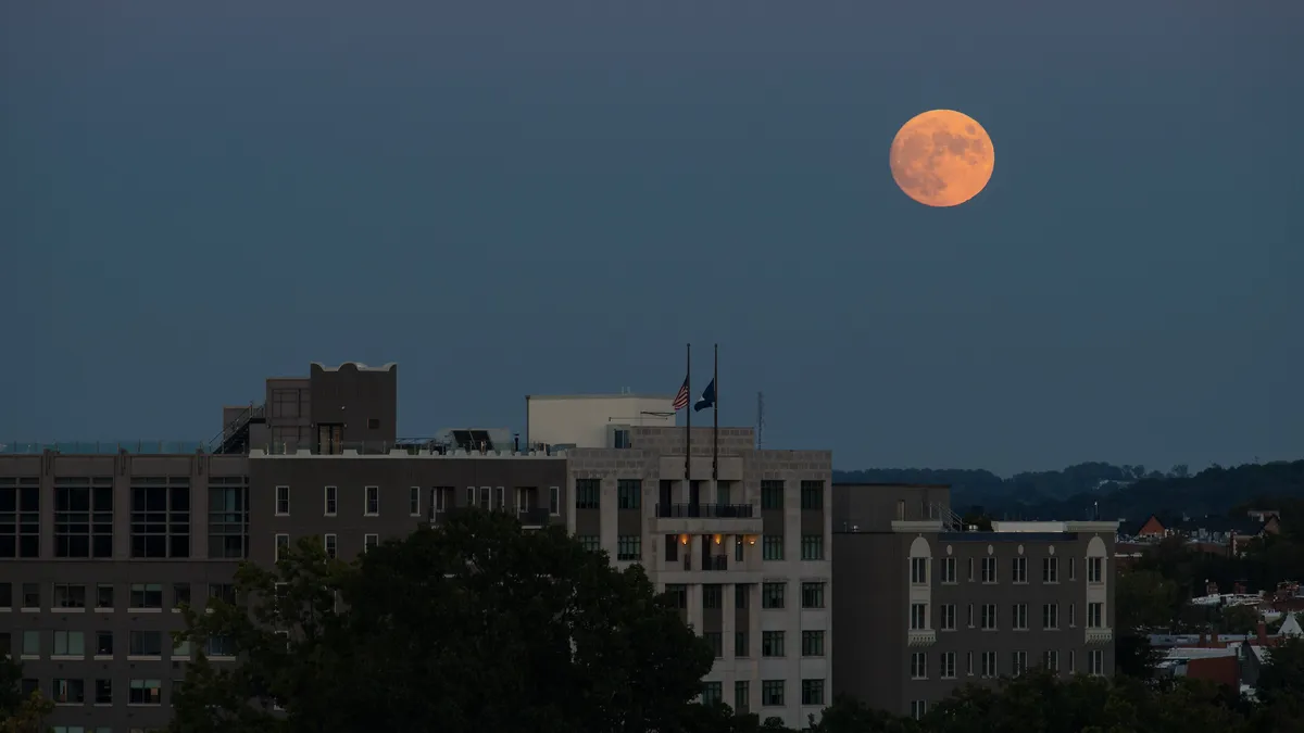 The moon rises over NASA's HQ in Washington, DC.