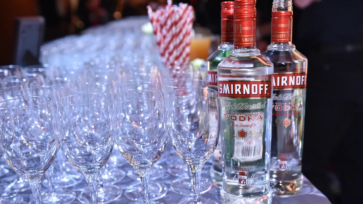 Smirnoff on display at an event next to glasses.