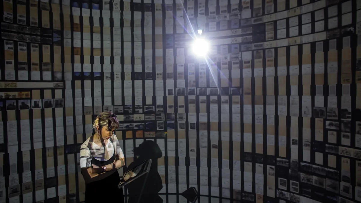 A woman views an art installation created with artificial intelligence.