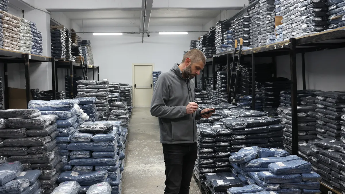 A man seen doing a quality check in a textile factory.
