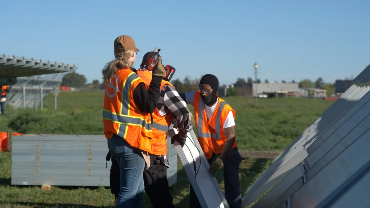 Workers fitting solar panels.