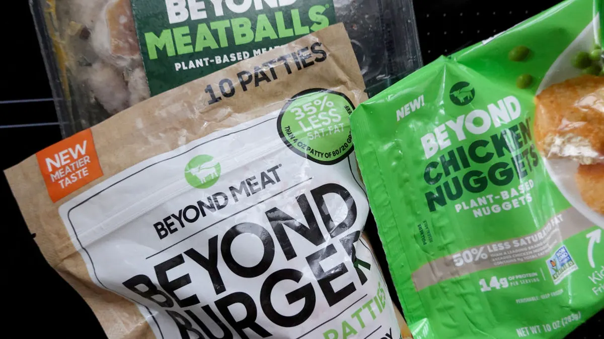 A Beyond Meat  burger, meatball as well as a chicken nuggets lay on a table