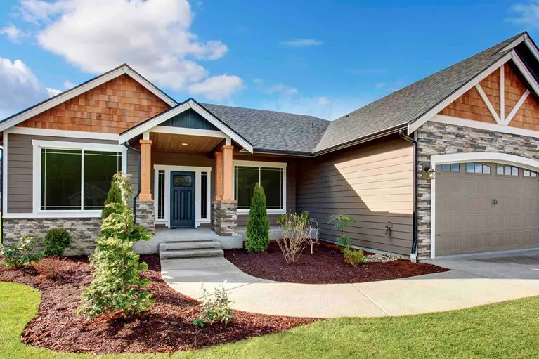 A single-family home with stone and brick-look siding.