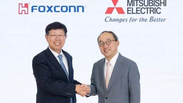 Pictured are Young Liu, Chairman of Hon Hai Precision Industry (left), and Kei Uruma, President & CEO of Mitsubishi Electric (right) shaking hands with the corporate logos of each company in the background.