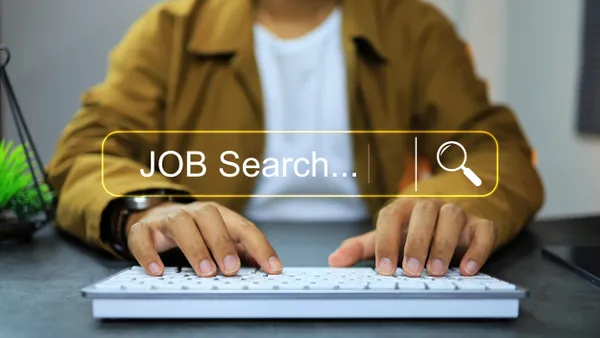 Man sitting at desk job searching on a computer