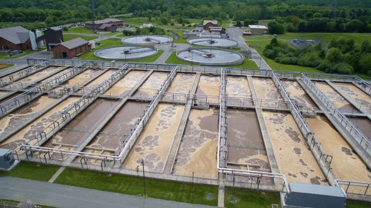 View from above of vast vats of brown liquid.