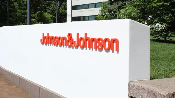 A wall bearing the Johnson & Johnson logo is seen outside of an office building.