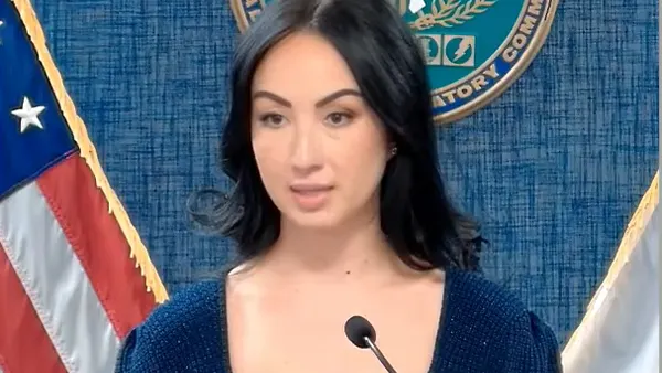 A woman speaks into a microphone.