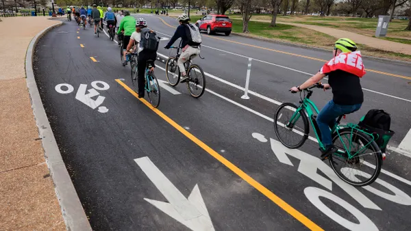 People riding bikes along a bike lane.