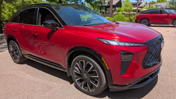 A 2027 red Infiniti QX65 SUV parked outdoors.