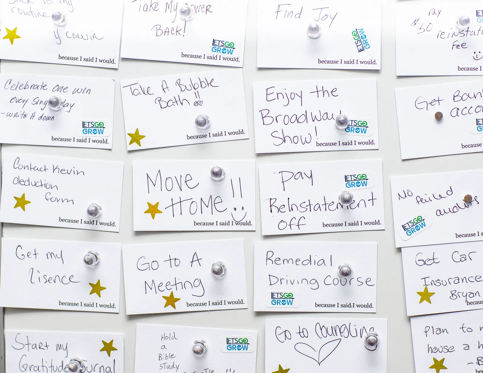 Dozens of small notes posted on a board with an employee goal listed on each one.