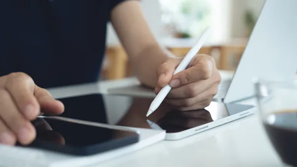 person uses tablet at computer