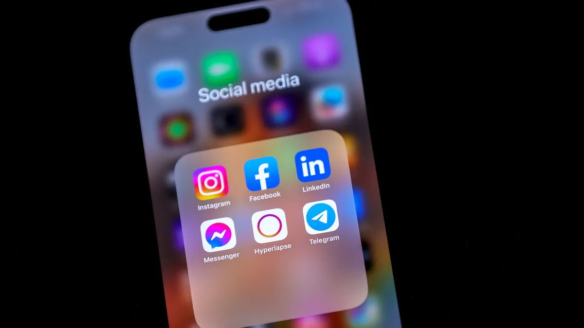 A phone screen shows social media apps.