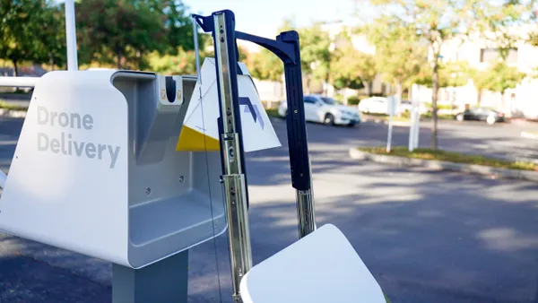 A Serve Robotics robot brings a package to an "AutoLoader" station for drone delivery.