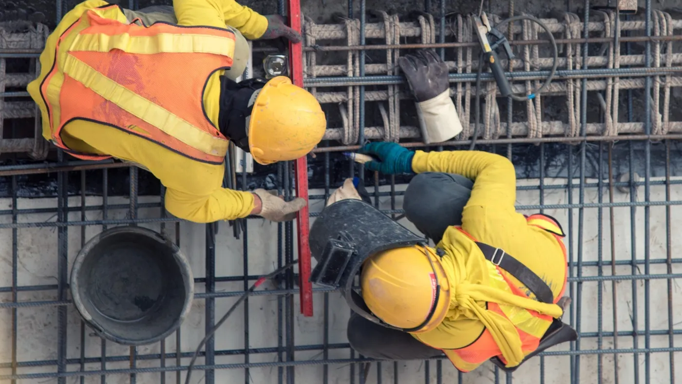 Ariel view of two construction workers on a project together.