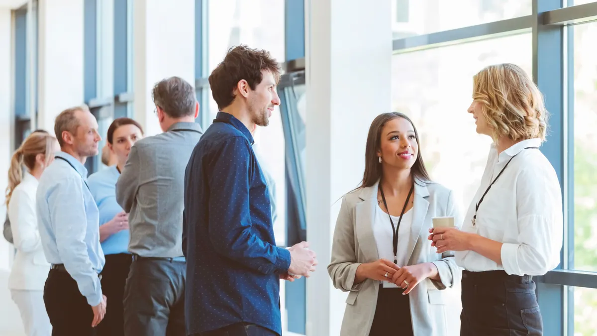 A group of business executives networking at a conference.