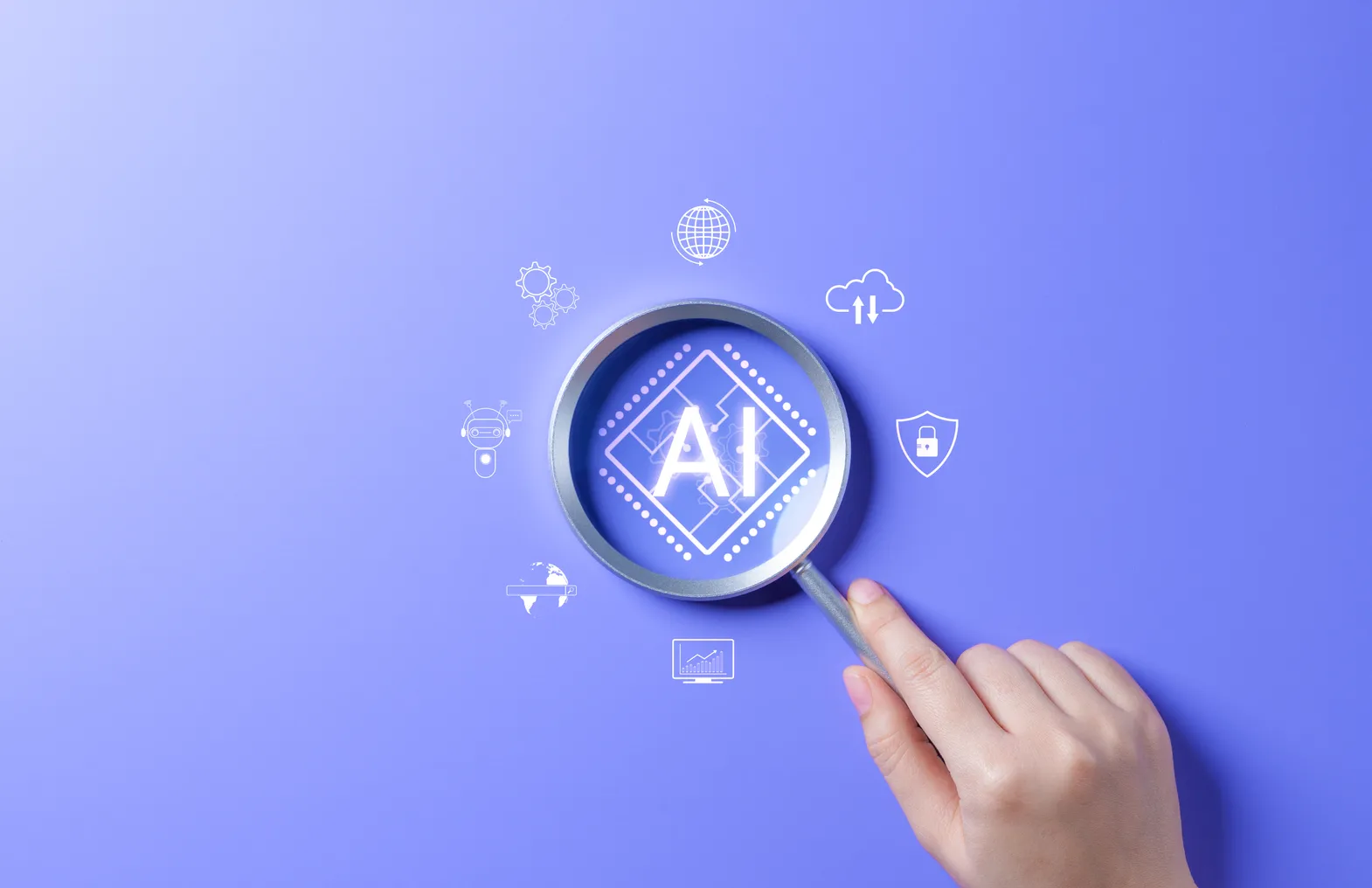 A hand holds a magnifying glass above a graphic that says "AI."