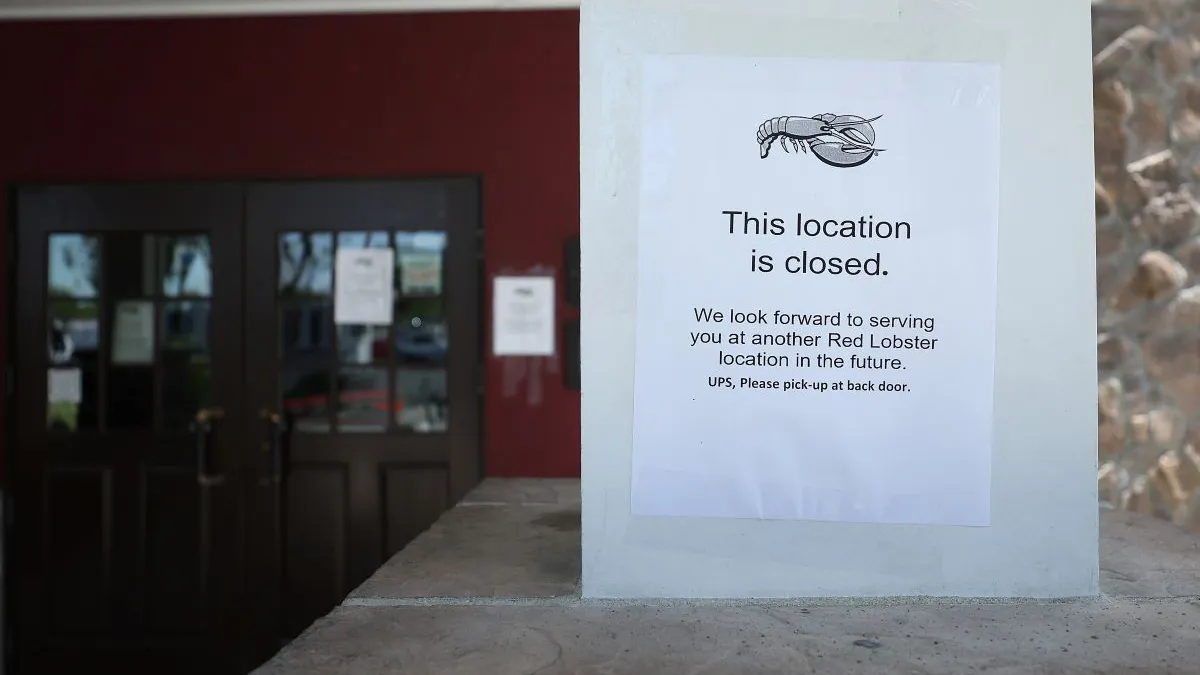 A sign with a lobster on it that says "This location is closed."