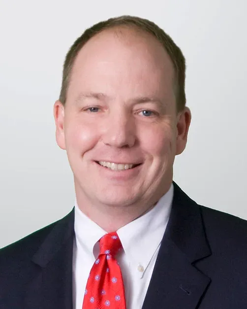 Headshot of a man in a suit