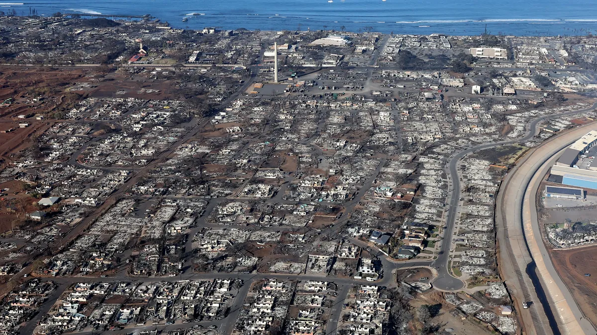 An aerial view depicts acres of homes and land burned and destroyed by wildfire.