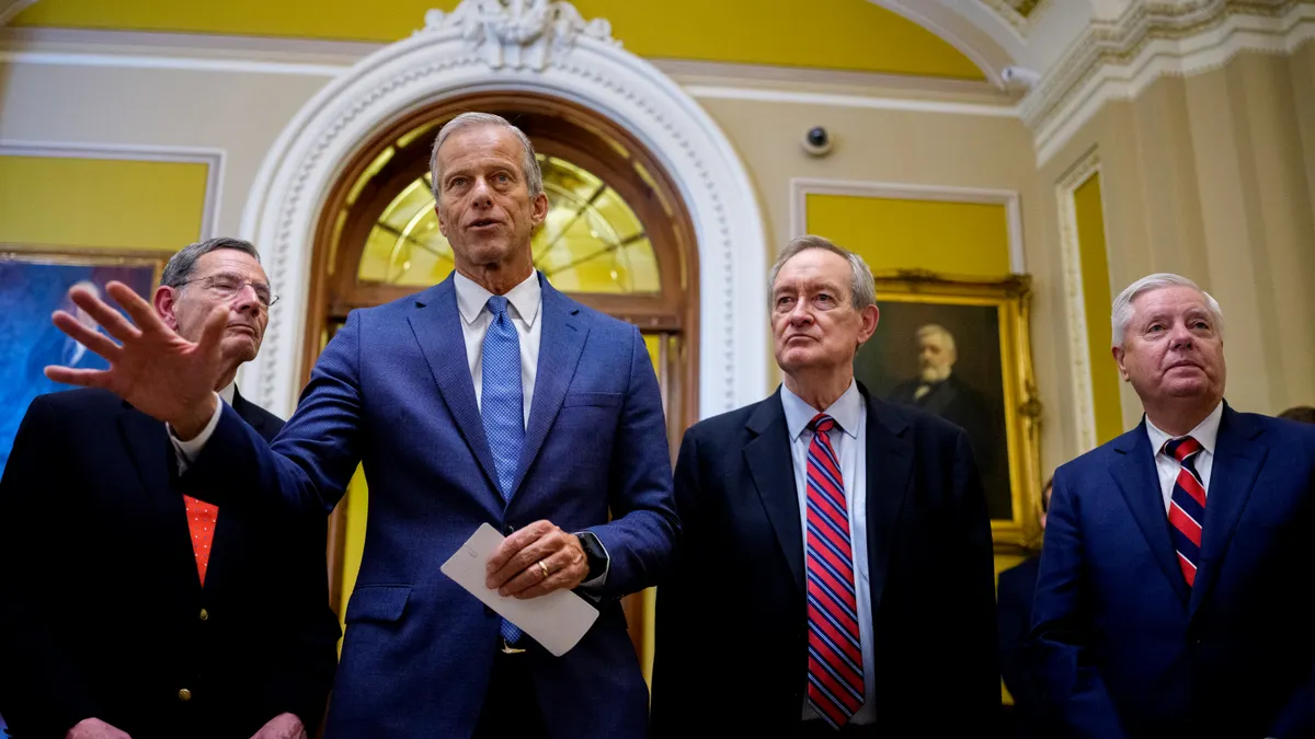 Senate Majority Leader John Thune, R-S.D., accompanied by Sen. John Barrasso, R-Wyo., Sen. Mike Crapo, R-Ind., and Sen. Lindsey Graham, R-S.C., speaks to reporters off the Senate floor after the Senate passed its megabill on July 1.