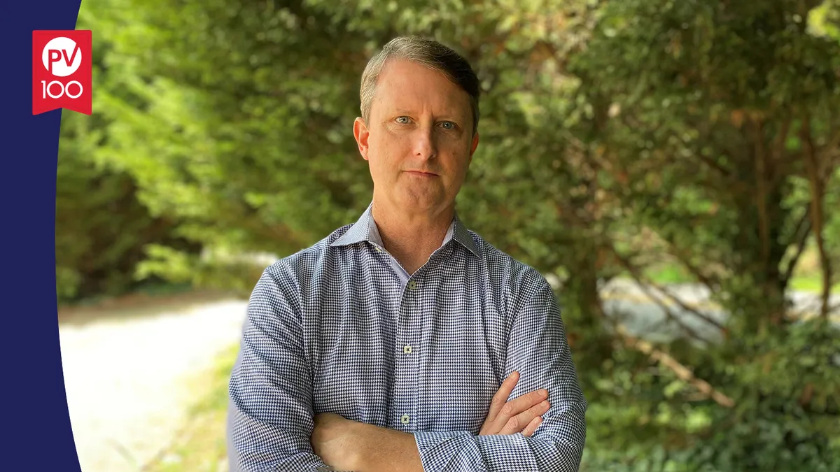 A portrait of Ben Yerxa framed with a banner icon that reads "PV 100"