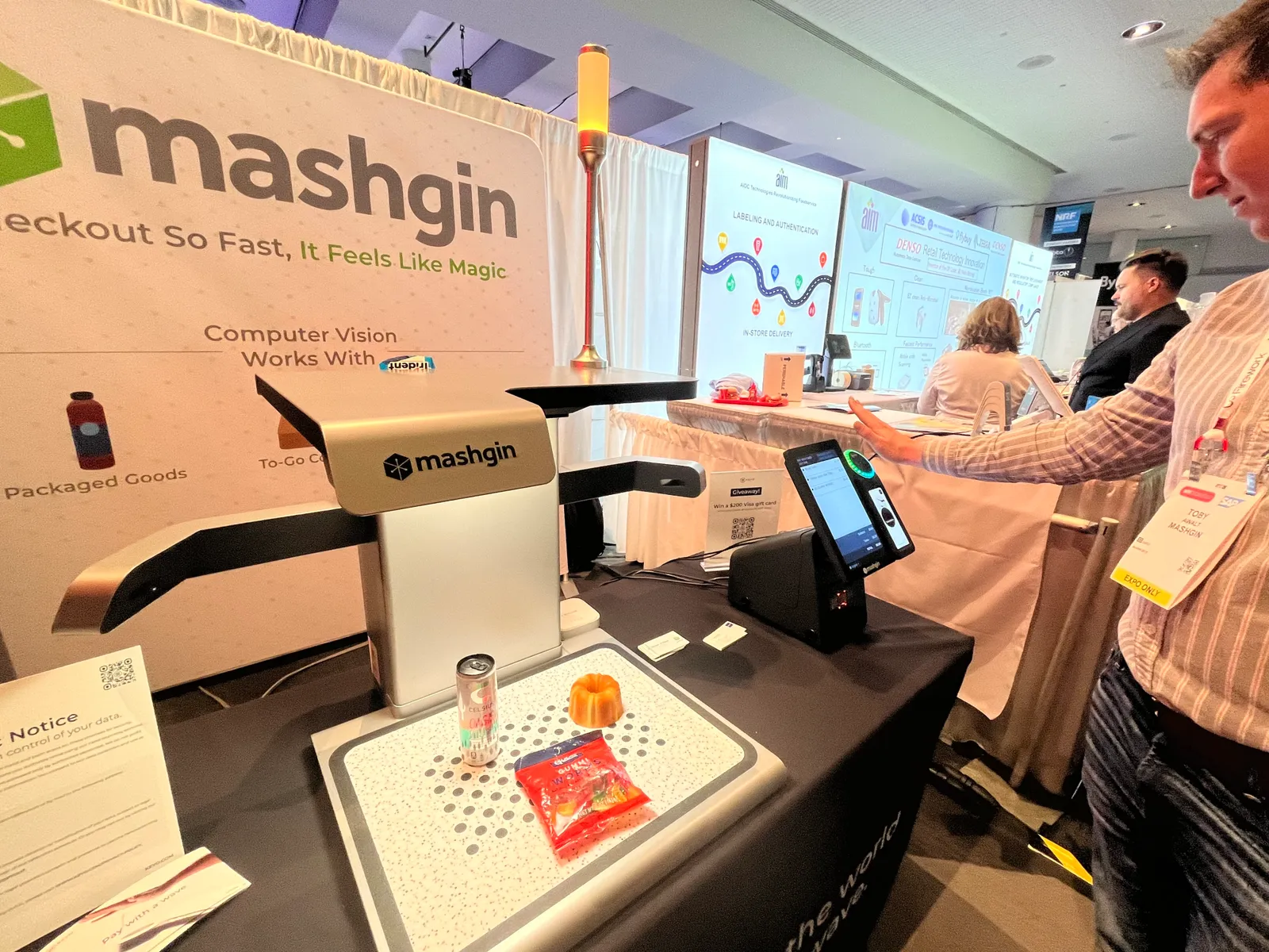 A demo of a frictionless checkout kiosk and palm-scanning device at a conference.