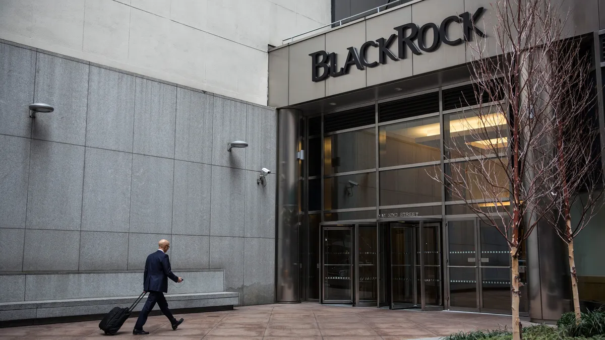 A man walks into a BlackRock office building.