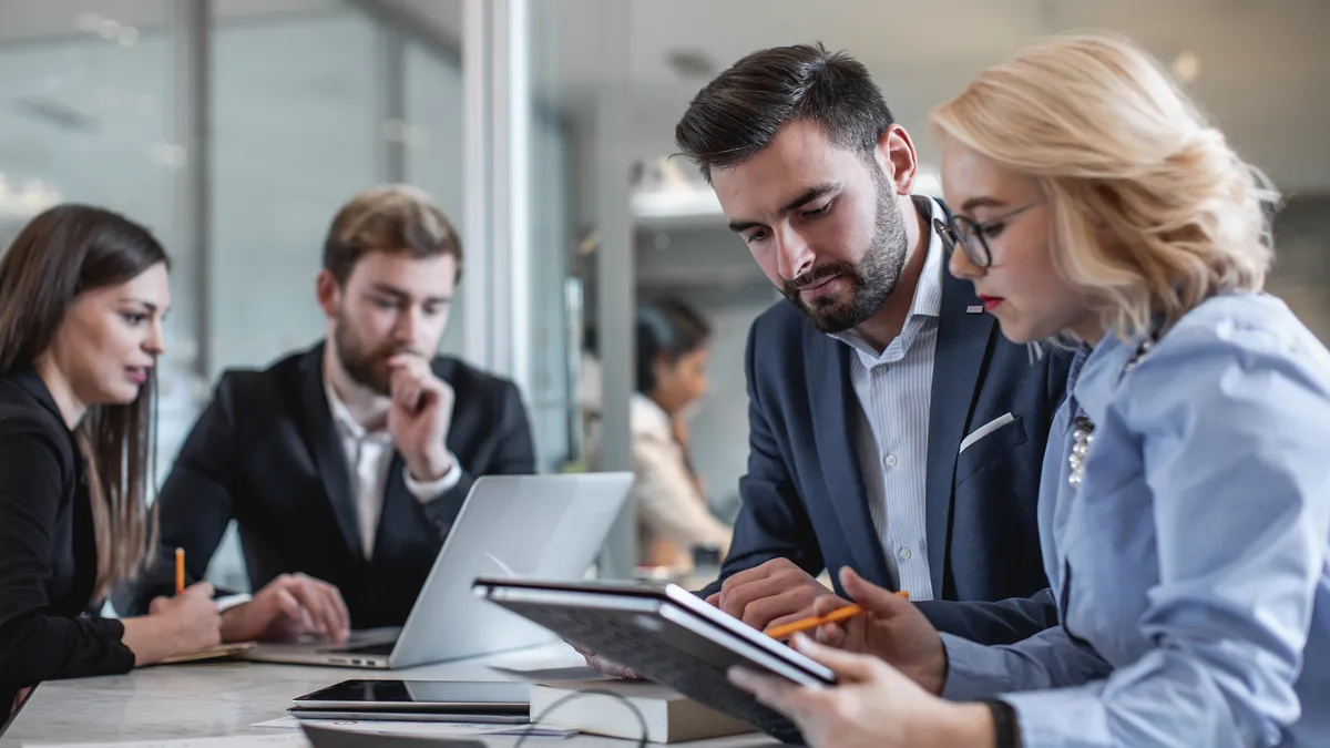 Business people in a meeting around a tablet