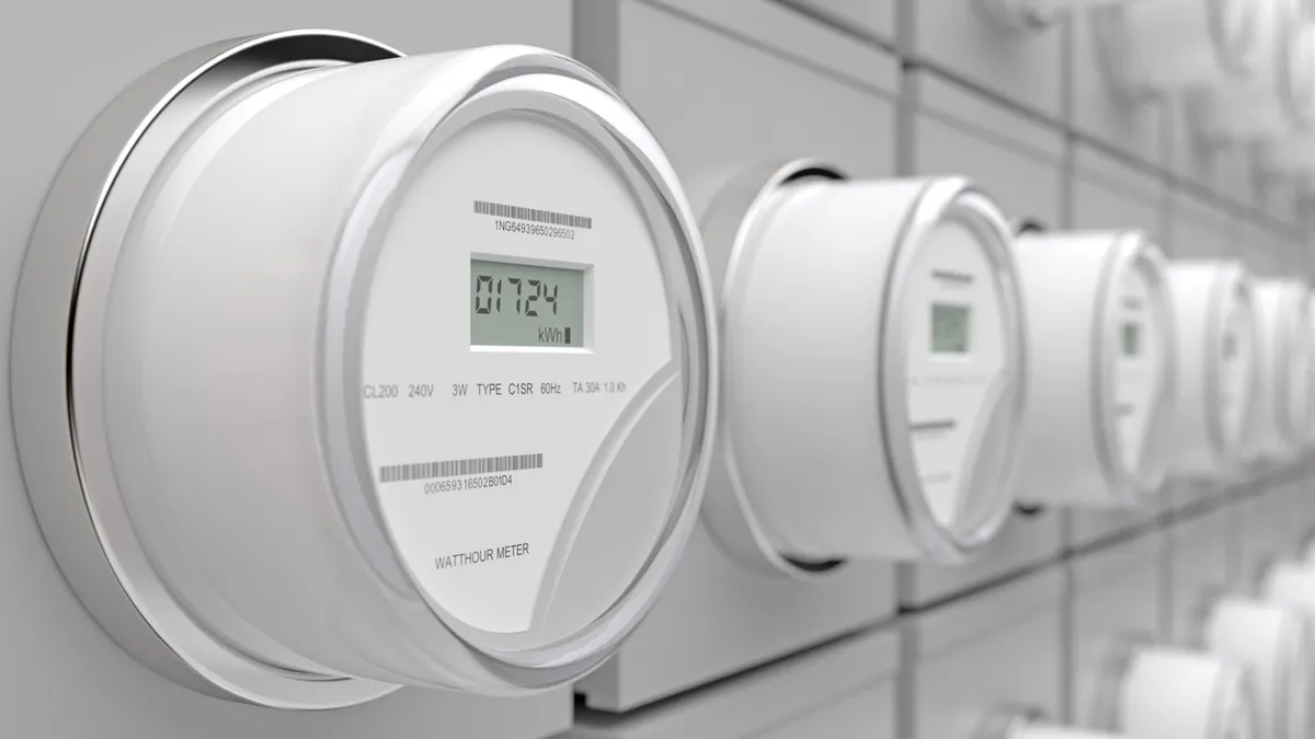 Close-up View Of Electric Meters On Wall With Blurred Background