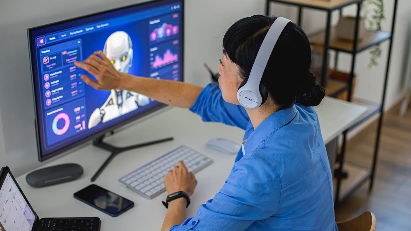 Woman interacting with artificial intelligence through computer interface