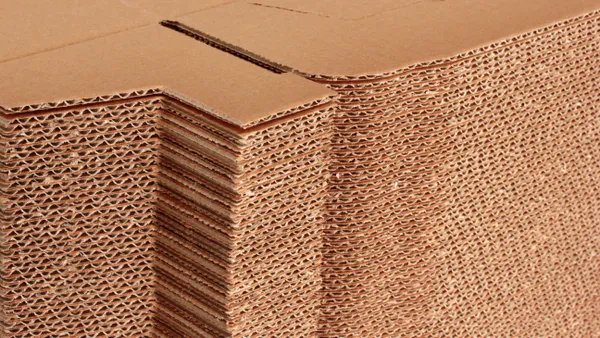 Close-up view of flat, stacked corrugated boxes.