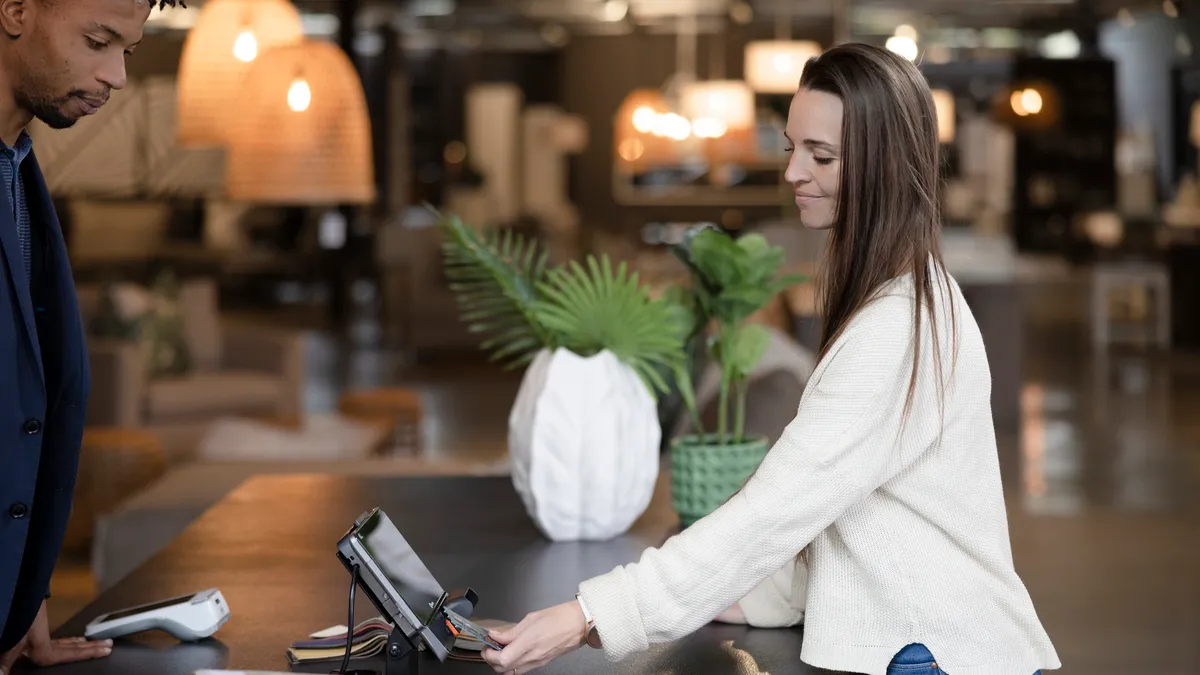 Woman checking out via POS machine