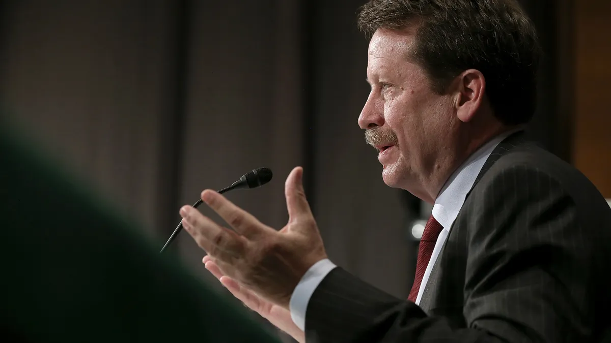 Dr. Robert Califf, FDA commissioner, speaking at a podium with hands up