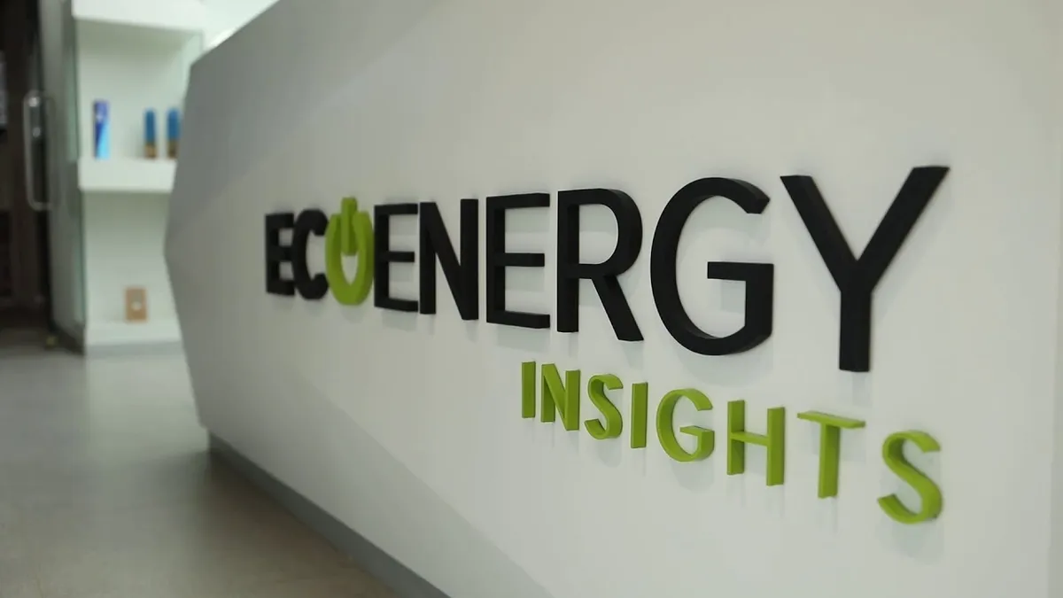 A white wall bearing a sign of Carrier's EcoEnergy Insights business